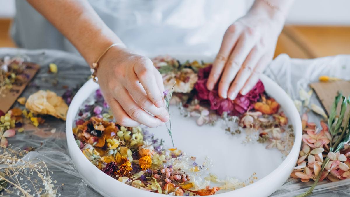 Woman drying and pressing flowers