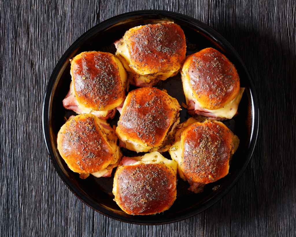 pull-apart pizza sliders with ham and swiss on baking dish