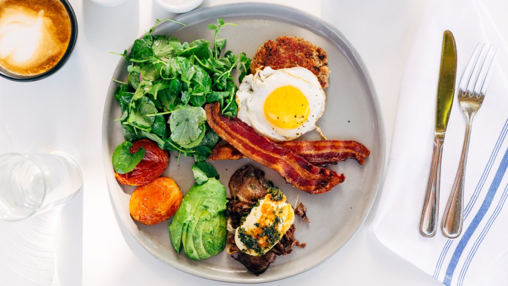 A plate of bacon, eggs, avocado and other high-protein and high-fat foods found in a keto diet, which can cause urine that smells like popcorn