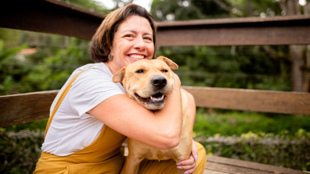 A woman and dog cuddling