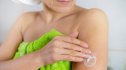 Mature woman moisturizing arm