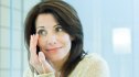 A woman with dark hair holding her hand to her eye as she tries to get rid of a stye overnight