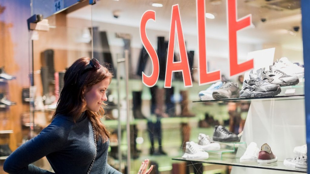 Woman looking in shop window of a shoe shop
