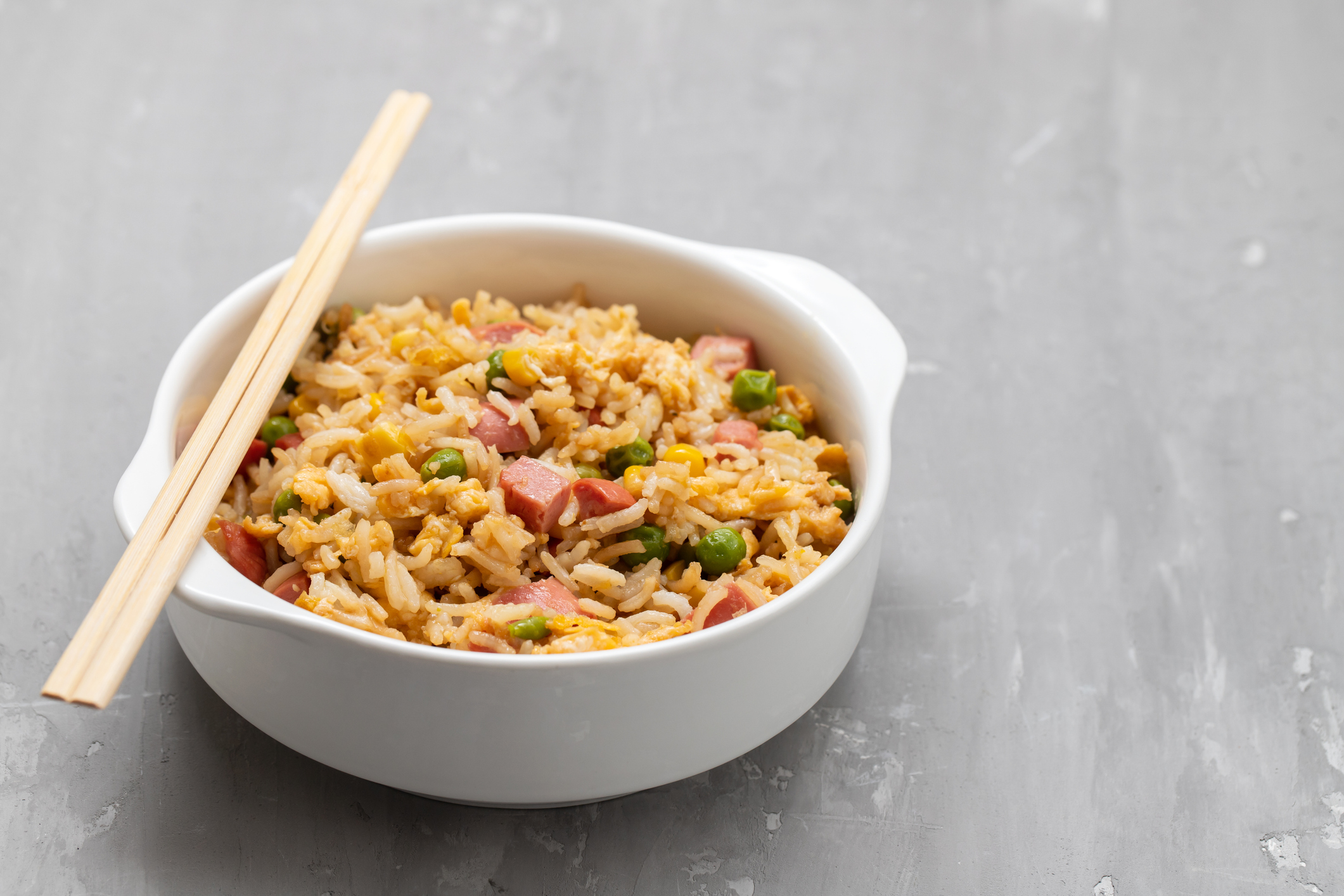Bowl of Spam fried rice with chopsticks