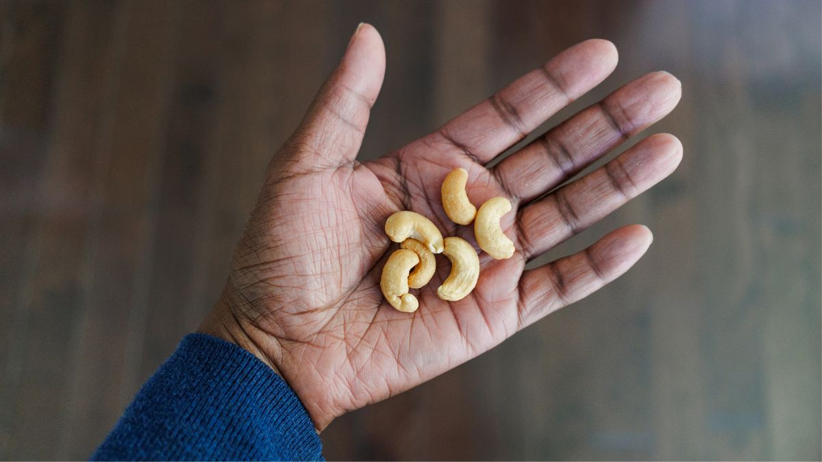 cashews in palm of woman's hand