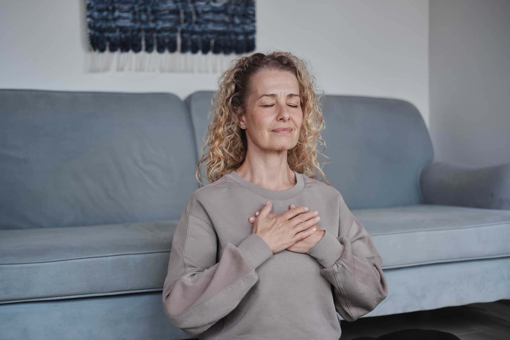 Mature woman touching her heart after heart disease treatment