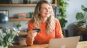 woman using debit card to pay bill on her phone