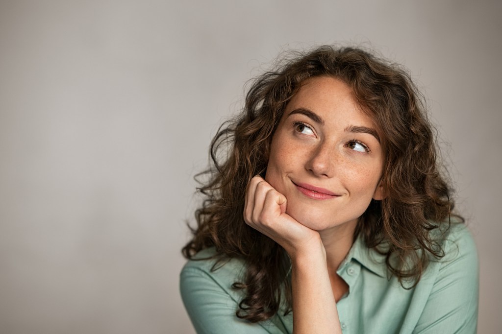 Woman thinking and trying to manifest positive thoughts how to get out of a rut