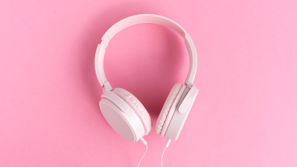 Headphones on a pink background, which can be used to play pink noise during a nap