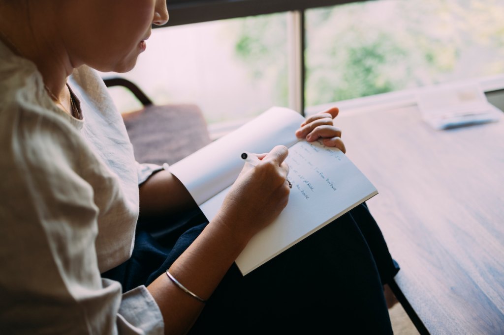 Woman writing in notebook