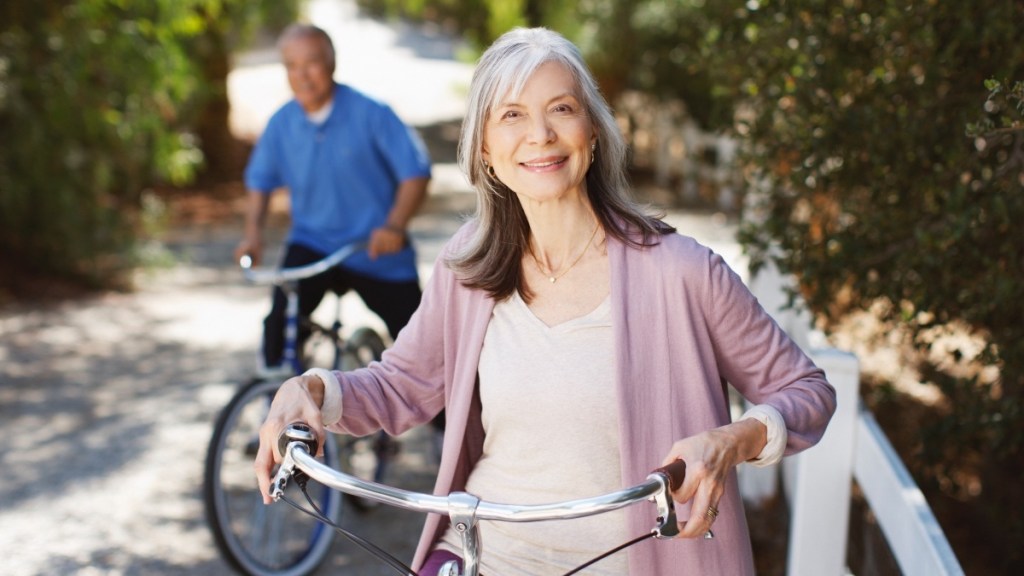 A mature woman on a bicycle to help treat her knee pain