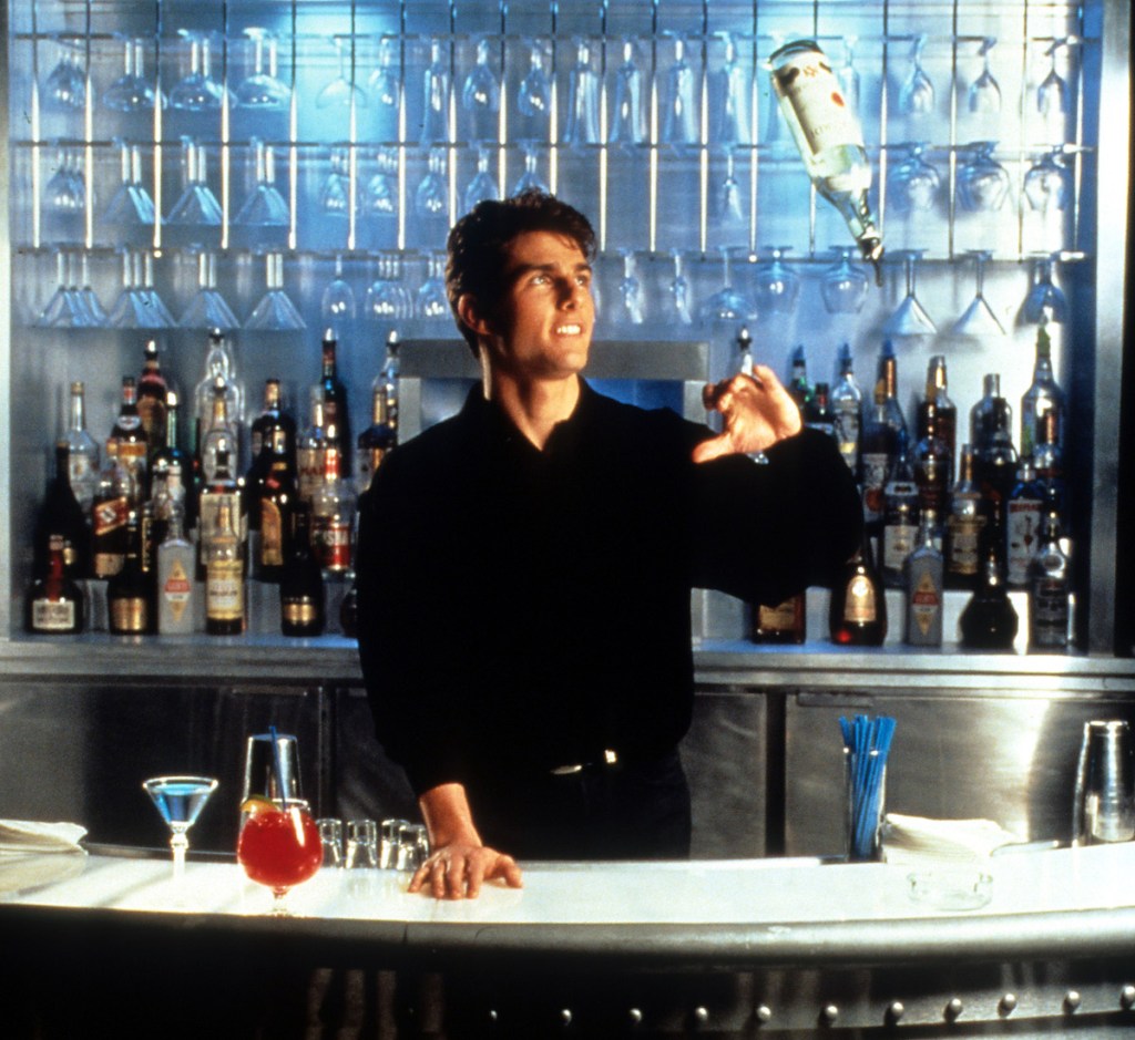 Tom Cruise showing his tricks as a bartender in a scene from 'Cocktail', 1988
