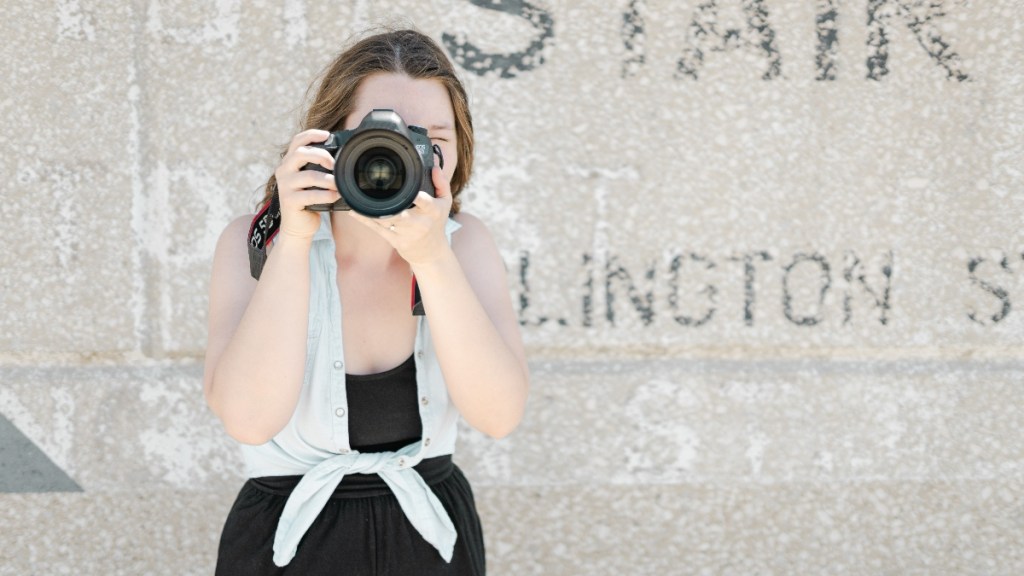 A woman shooting a photo showcasing the rule of thirds