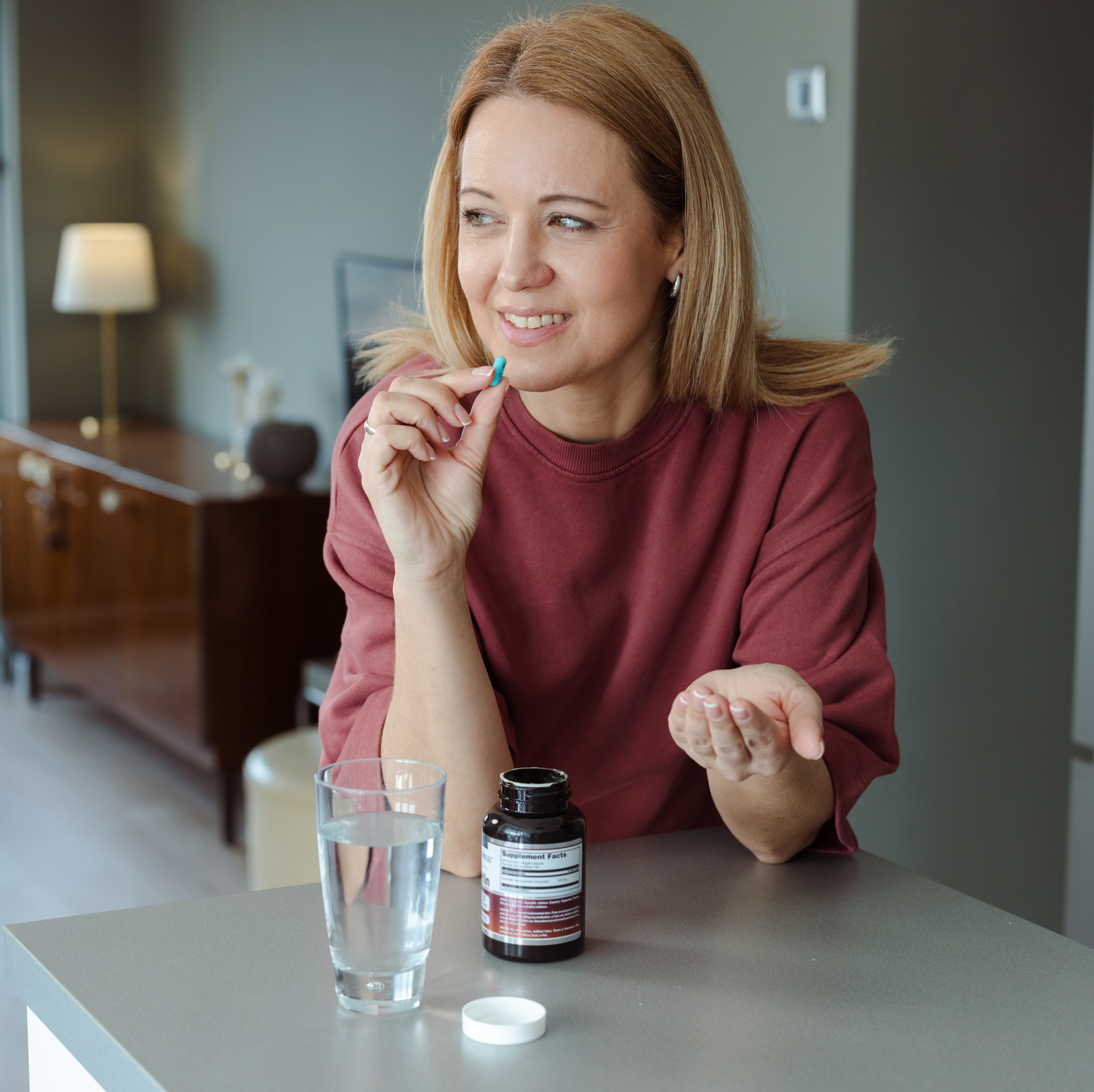 Woman taking a supplement