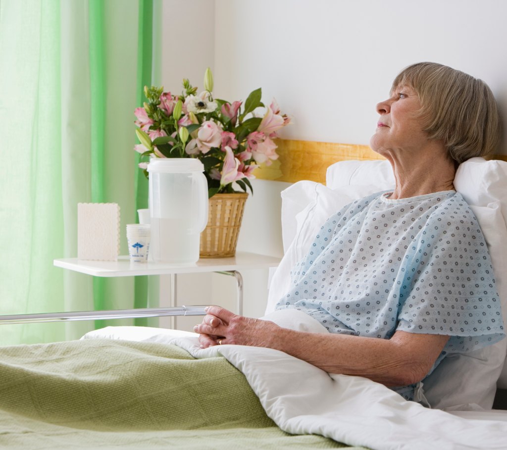 Old woman recovering in bed