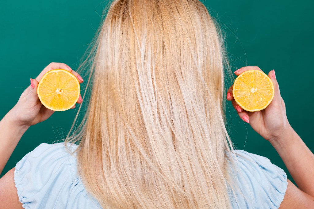 blonde hair holding lemons for hair lightener