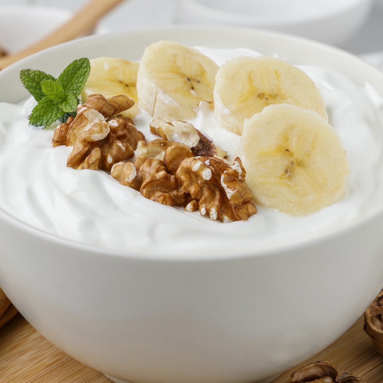 Homemade yogurt with sliced banana and walnuts