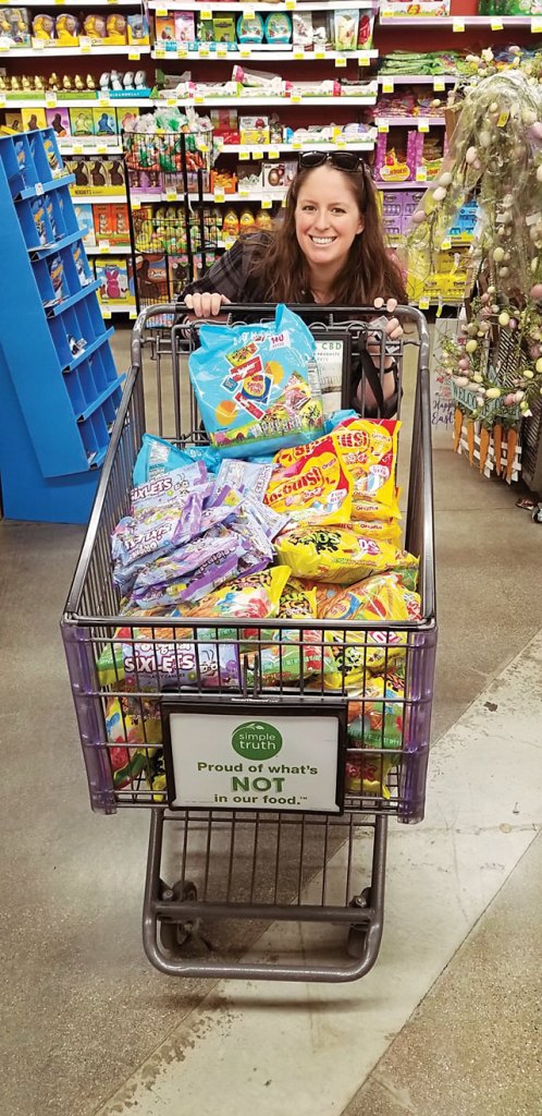 Quinn picking up candy donated by Kroger for an Easter egg hunt