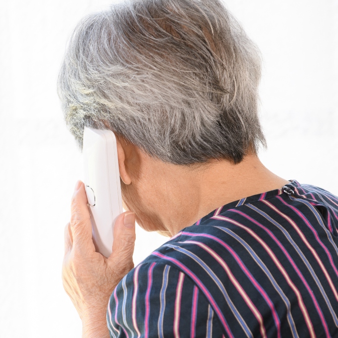 An elderly woman on the phone