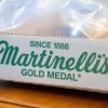 Close-up of Martinelli's Gold Medal apple juice packaging on a wooden surface