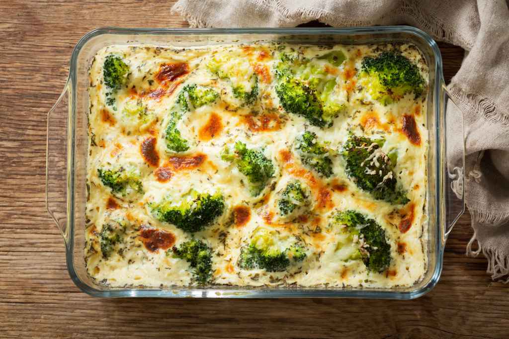 casserole with broccoli, rice, cheese and cream sauce in baking dish