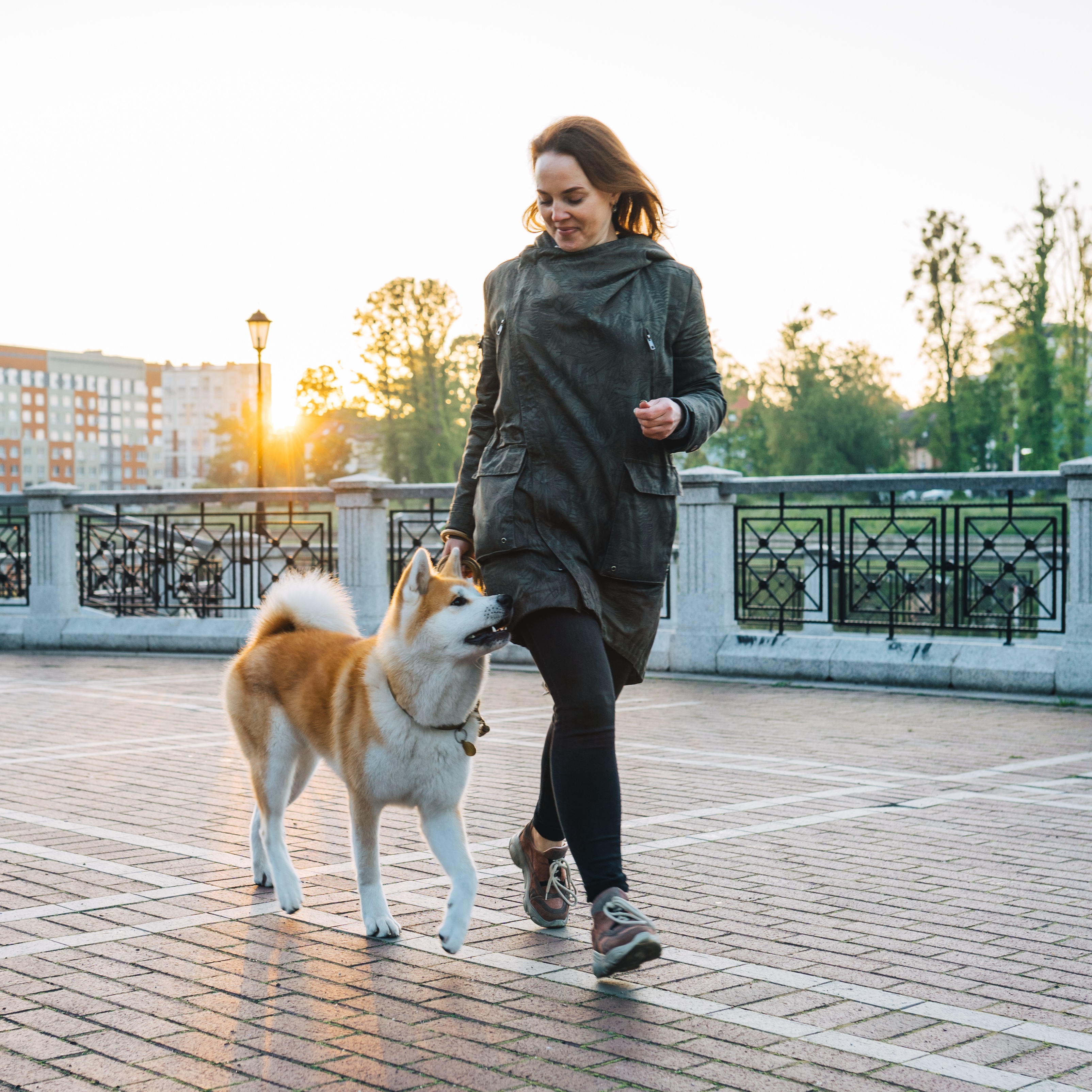 woman outside walking with her dog getting benefits of dog walking for weight loss