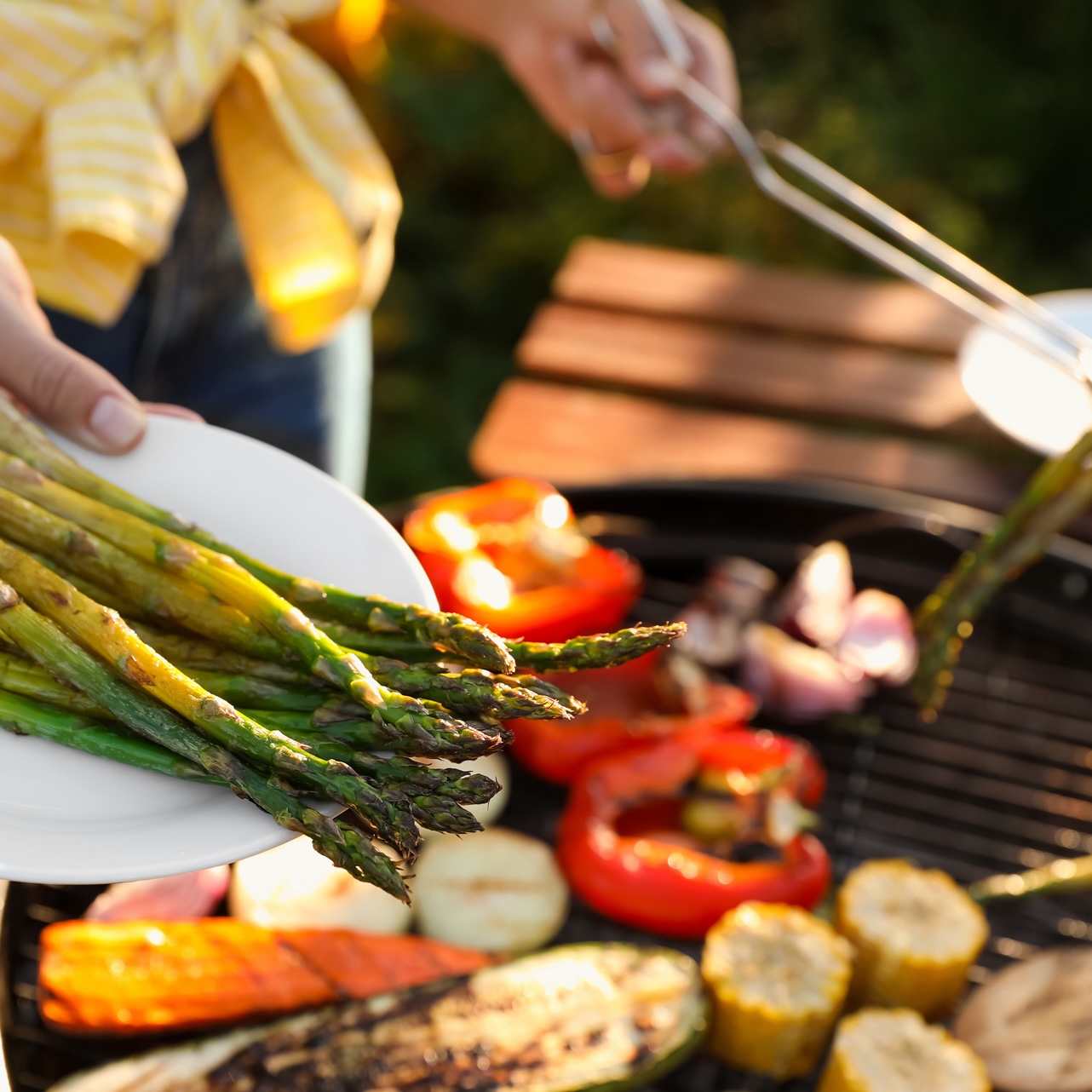 mature woman grilling vegetables as part of healthy summer eating