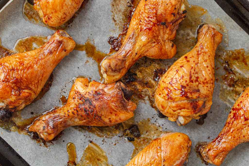 Close up of Katie Lee Biegel's old-fashioned oven-fried chicken on baking sheet with sweet tea marinade