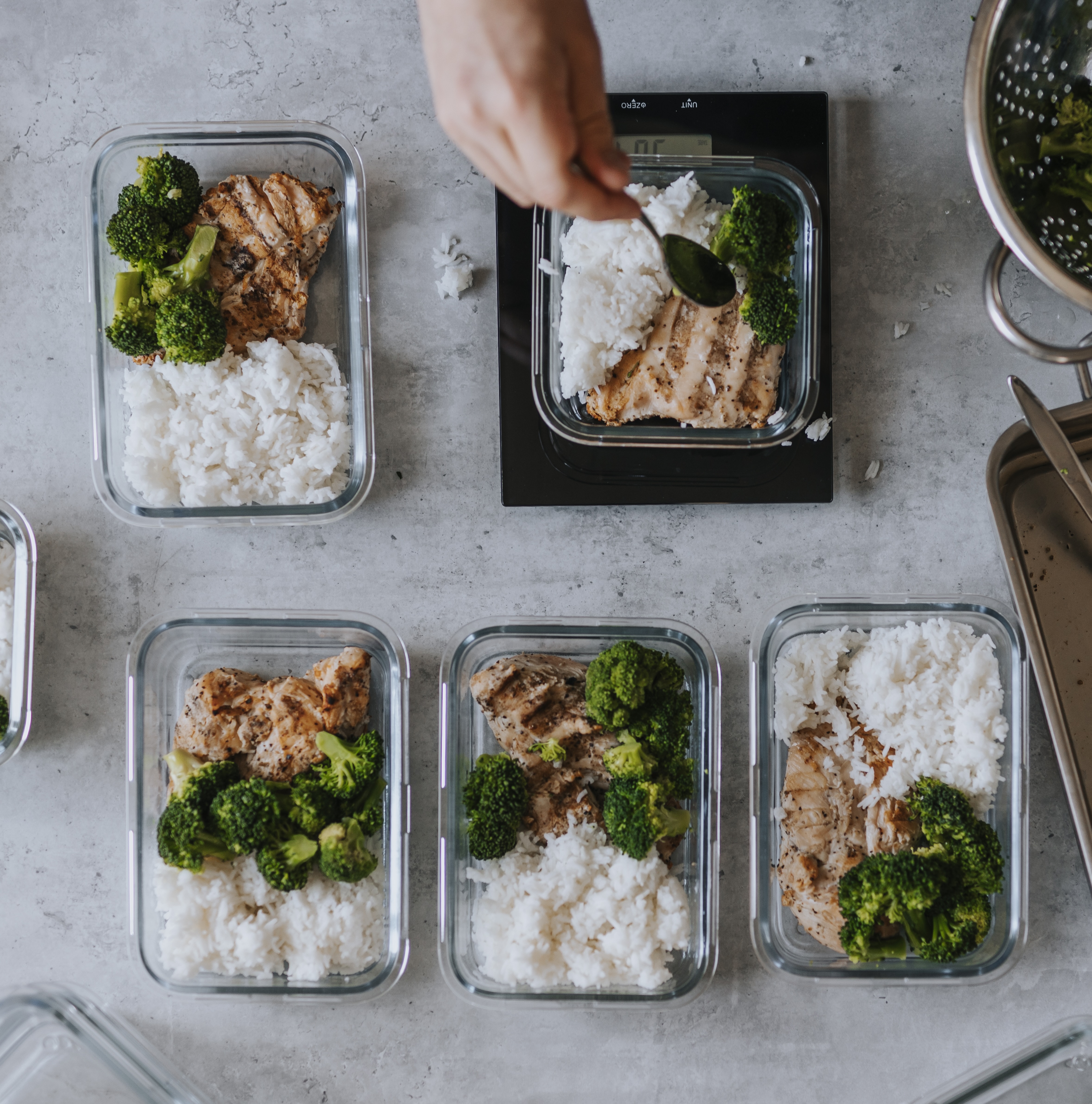 broccoli, chicken and white rice in glass containers as part of meal prep ideas for weight loss