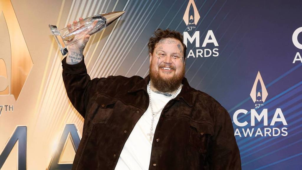 man holding up award