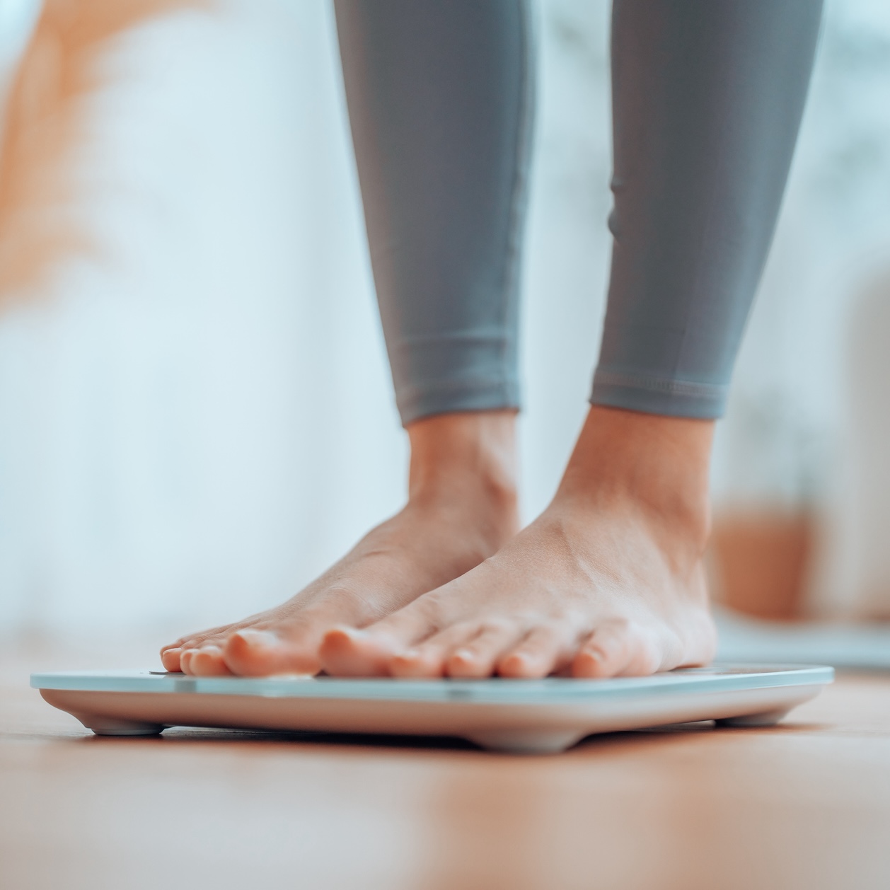 closeup of mature woman's feet weighing herself