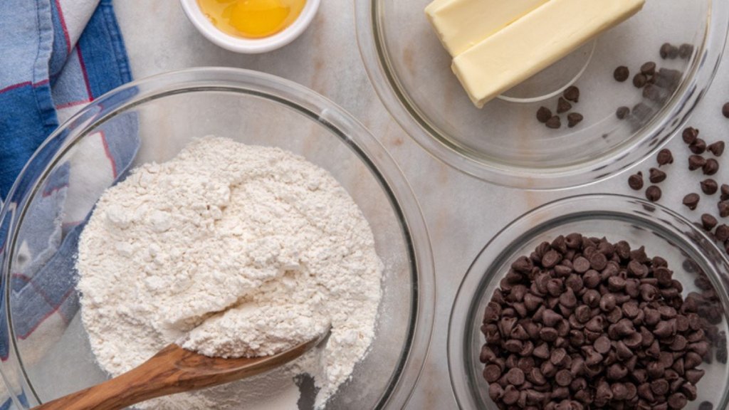 ingredients on table to make a skillet brookie, including butter, flour and chocolate chips