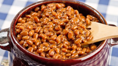 A pot of BBQ baked beans as part of a recipe showcasing how to make them