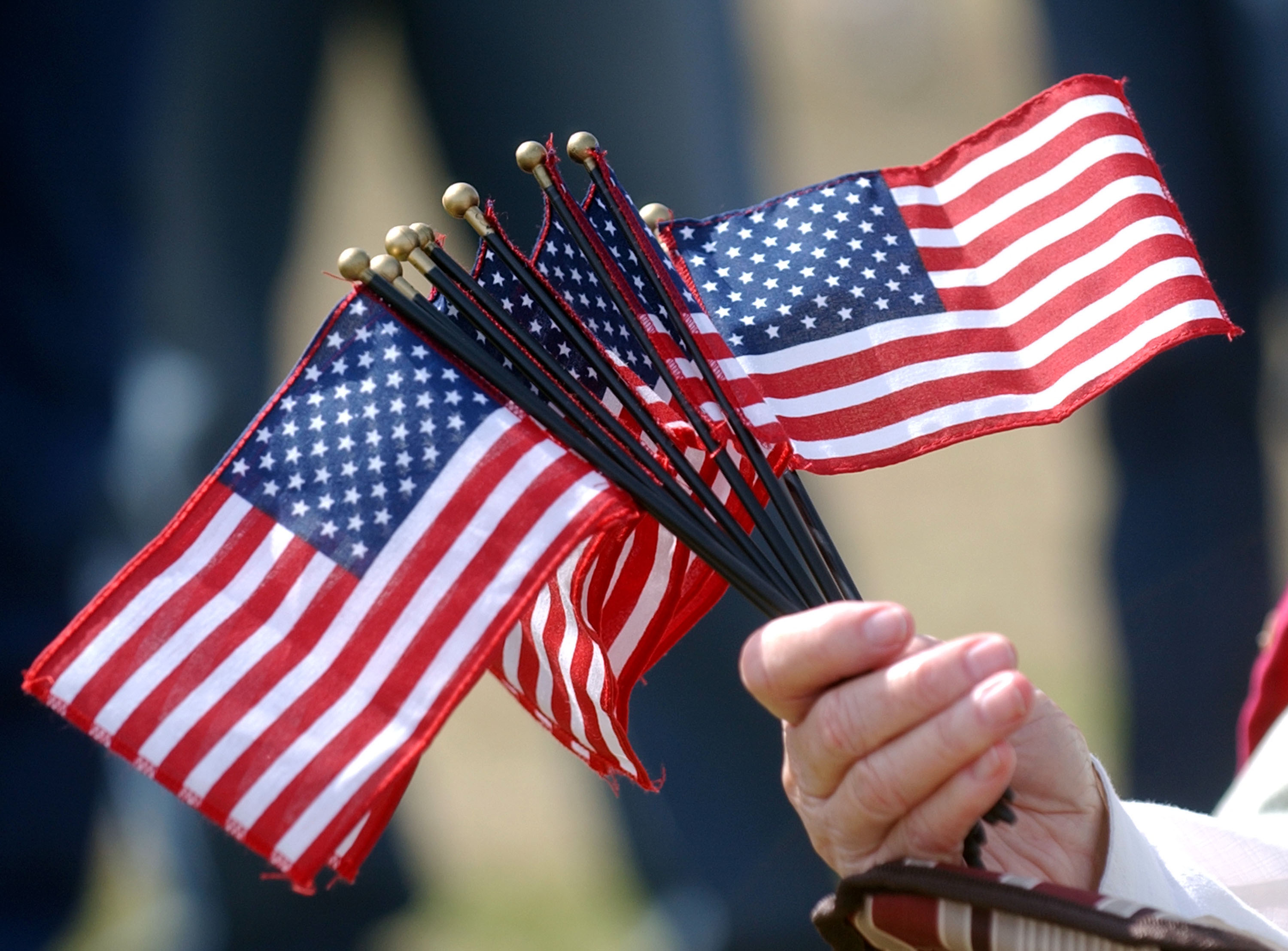 FORT STEWART, GA - FEBRUARY 20: Myra Waldroop holds a fist full of flags February 20, 2005 during a homecoming celebration for 150 soldiers from the Army's 3rd Infantry Division, 293rd Military Police unit at Fort Stewart, Georgia. The MP's have been deployed since early March 2004 to providing military police support in Mosul, Iraq. (Photo by Stephen Morton/Getty Images)