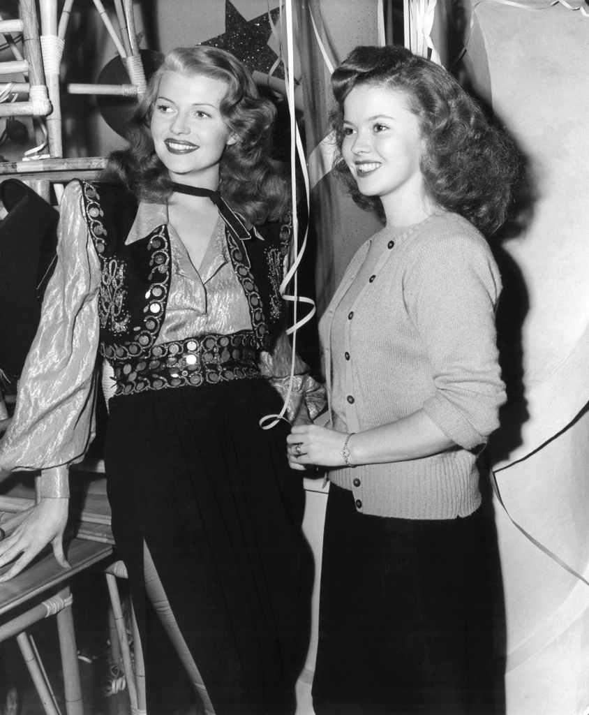 GILDA, from left: Rita Hayworth with visitor Shirley Temple on set, 1946