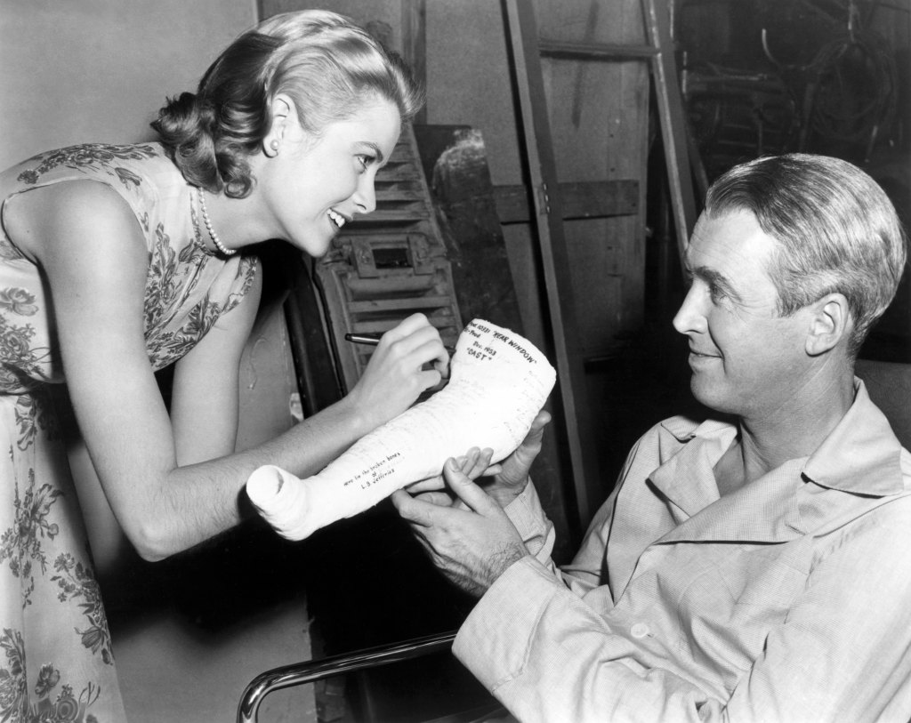 Grace Kelly signs mini cast for James Stewart on the set of Rear Window