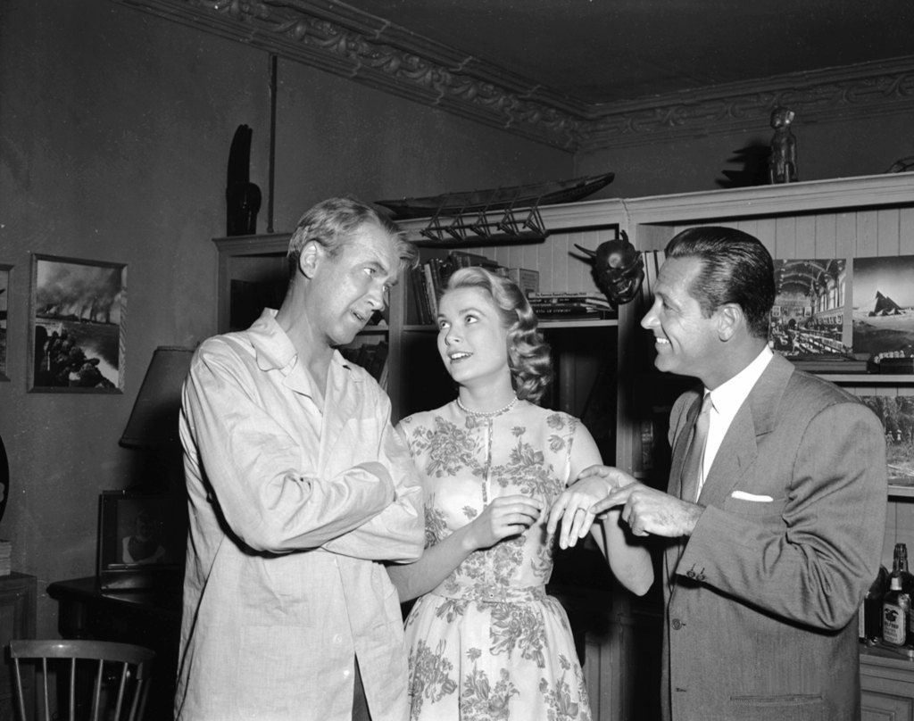 William Holden points out Grace Kelly's engagement ring to James Stewart in a moment of fun on the set of Hitchcock's 'Rear Window'