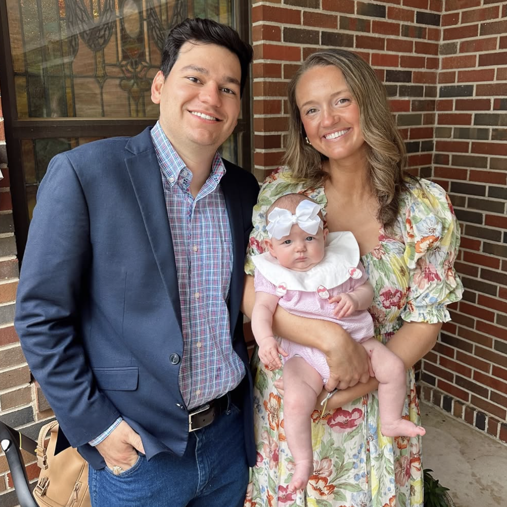 Alex Drummond holding daughter Sofia with husband Mauricio Scott