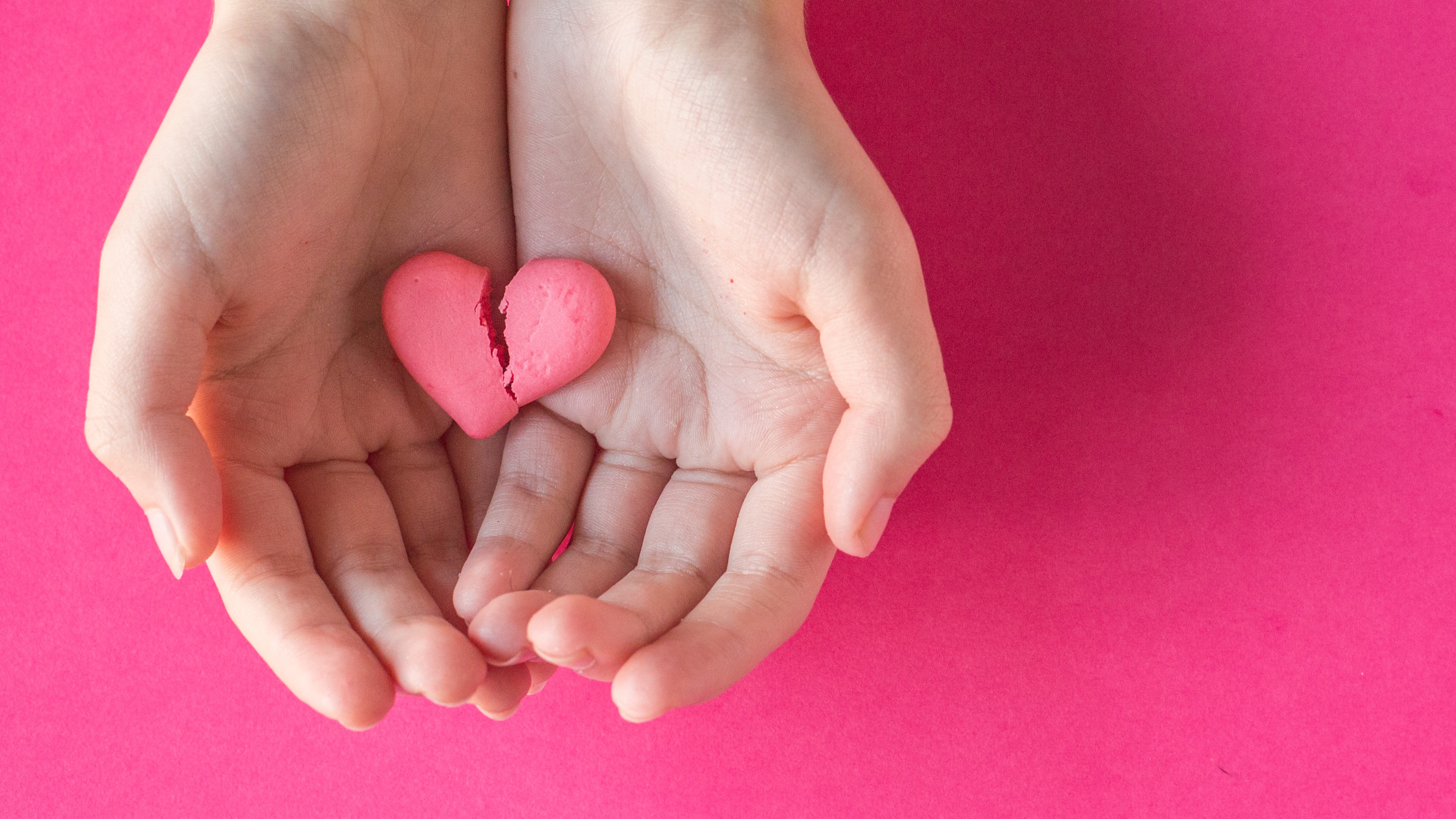 Woman holding broken candy heart