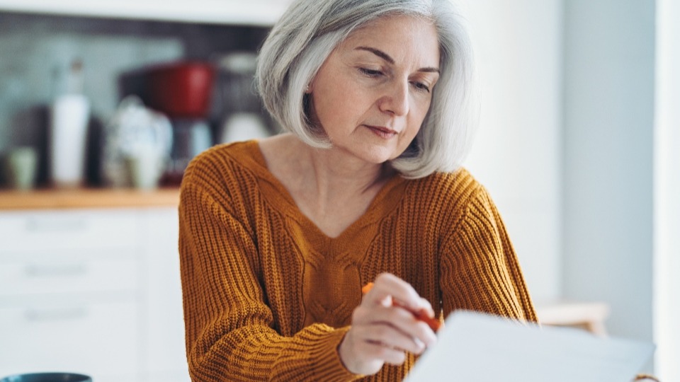 An older woman working on taxes
