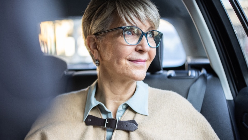 A senior woman in a car