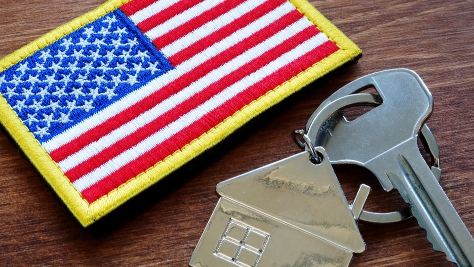 A house key by an American flag