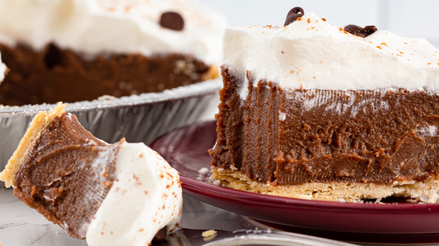 Slice of classic Southern chocolate pie with meringue topping, with fork