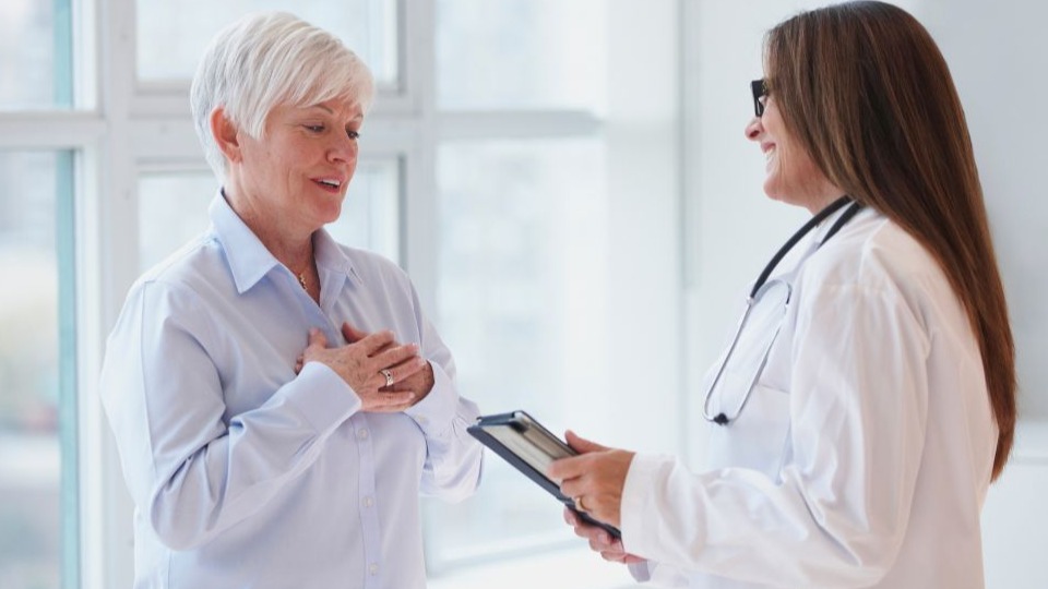 woman talking to doctor in office about heart disease and intermittent fasting