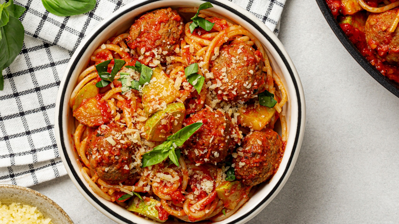 Bowl of Ina Garten's spaghetti and meatballs with parmesan cheese