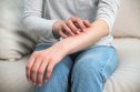 Picture of woman scratching her arm
