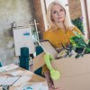 middle-aged woman carries a box with her personal items after being laid off