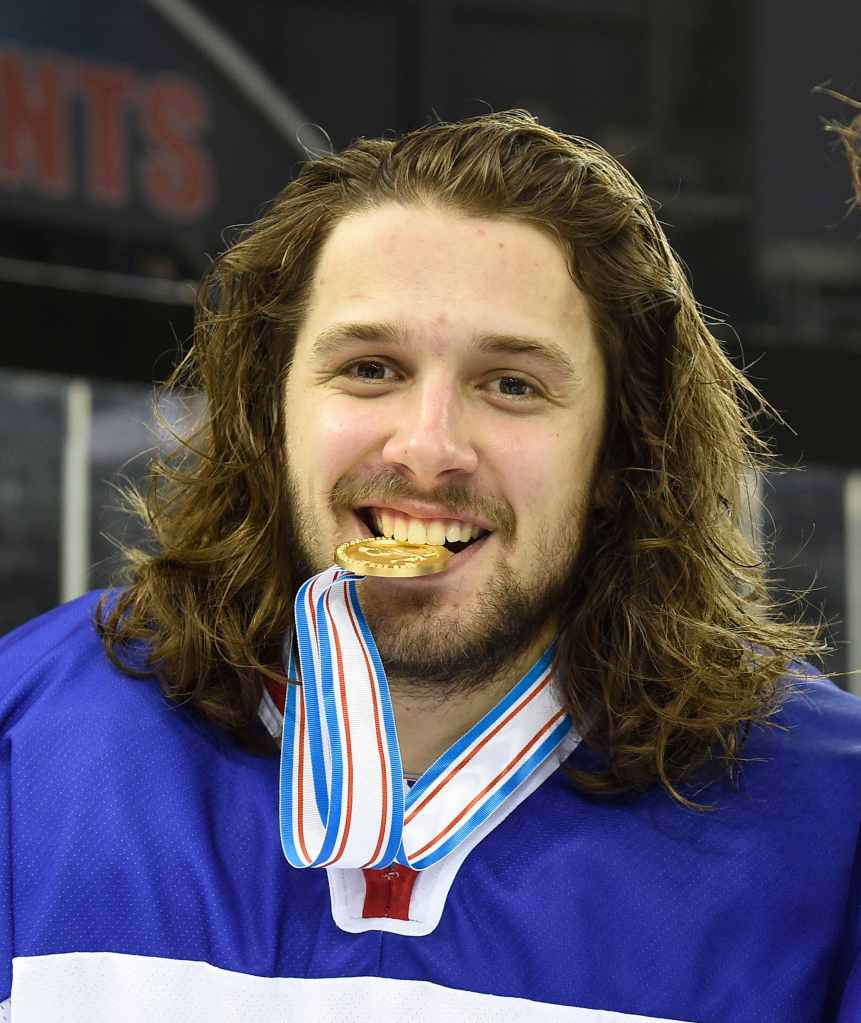 man holding gold medal