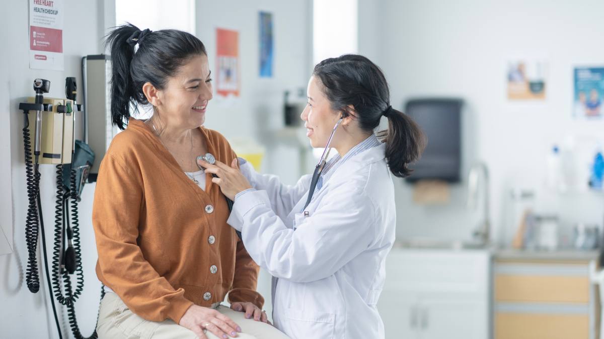 Woman getting heart checked by doctor