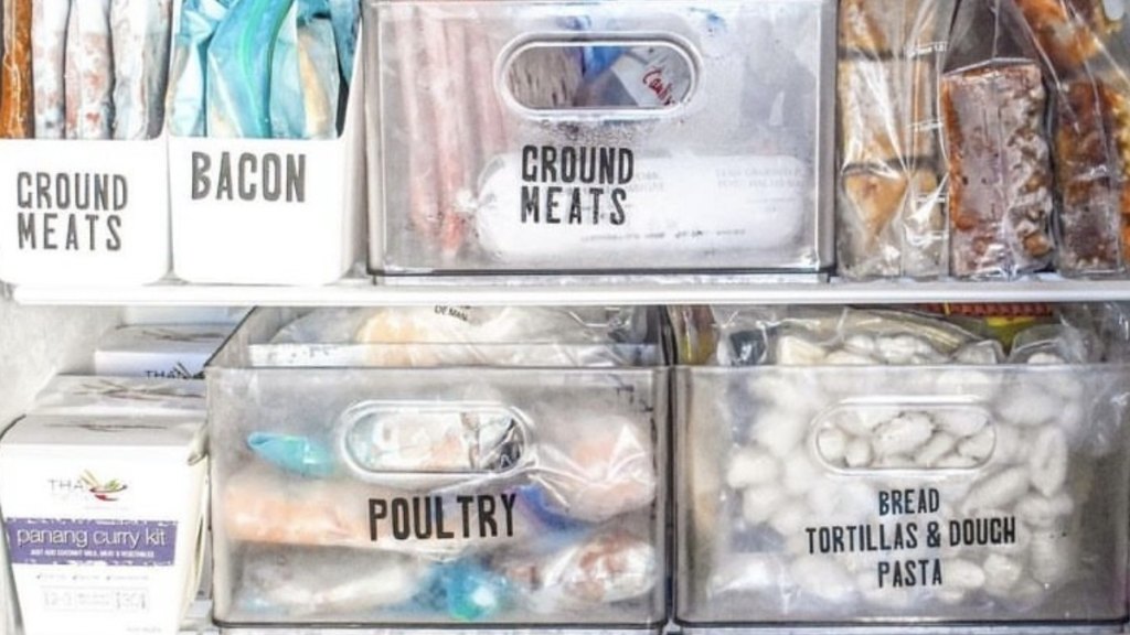 An organized freezer with items grouped in bins